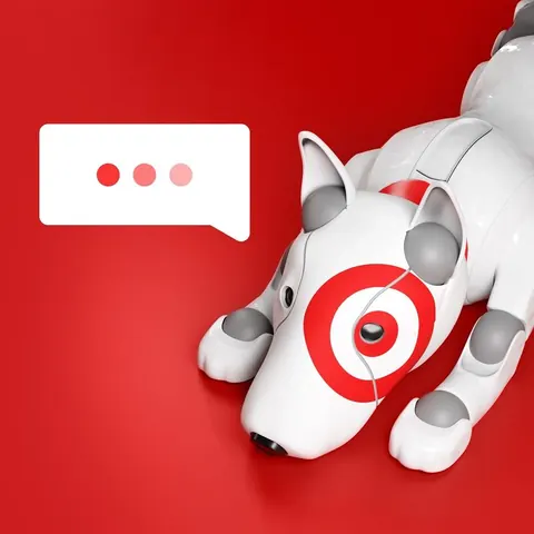 White robot dog with a red bullseye eye lies on a red background beside a speech bubble showing three typing dots.