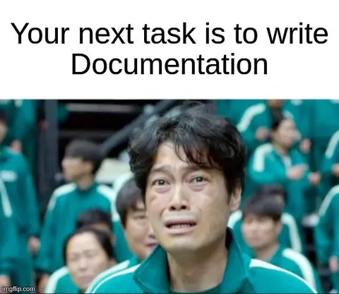 Distressed man in a green tracksuit reacts to the caption: Your next task is to write Documentation.