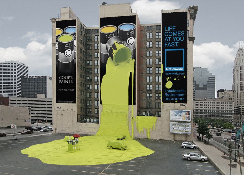 Giant Coop's Paints banners appear to spill green paint over a parking lot, beside a Nationwide insurance ad.
