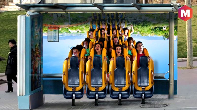 Transit shelter fitted with roller-coaster seats and riders so waiting looks like an amusement ride.