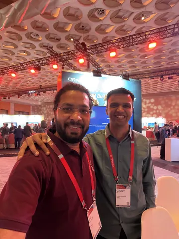 Two smiling men take a selfie at an Oracle conference, one wearing a badge reading Gaurav from Artisans Commerce Cloud.