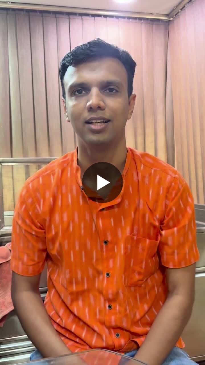 A man in an orange printed shirt speaks to the camera in a video about the risks of cleaning ears with cotton buds.